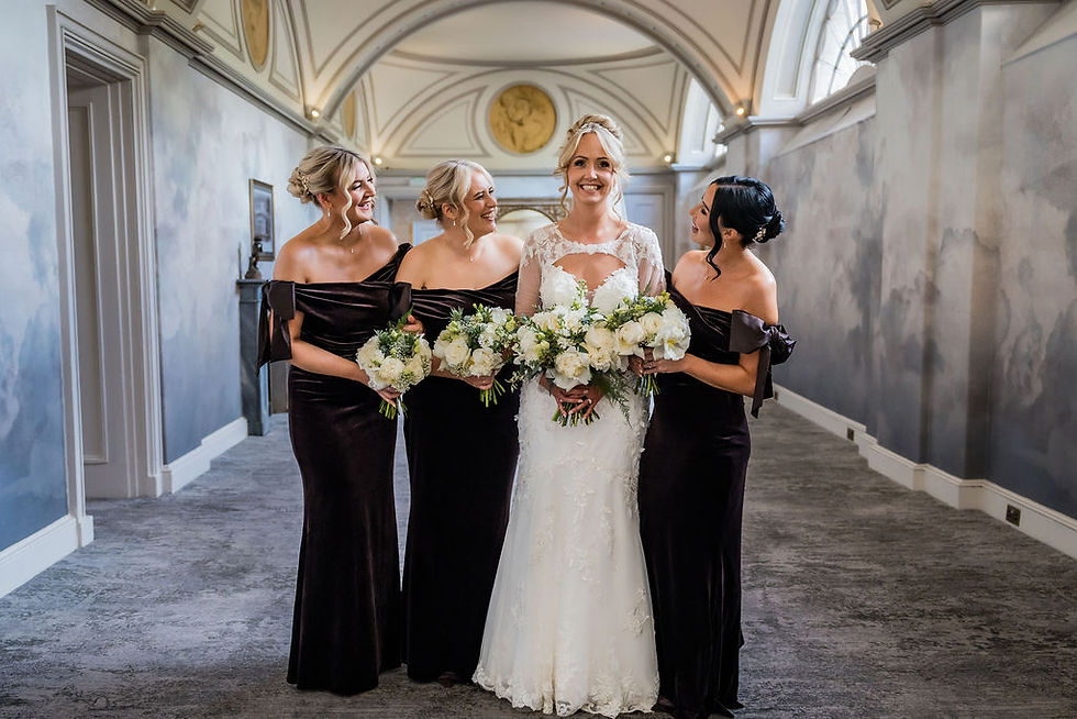 Bride standing with her bridesmaids inside Balbirnie House after ceremony.