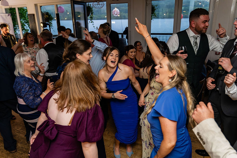 Packed dance floor as wedding guests celebrate together at Venachar Lochside in Scotland.