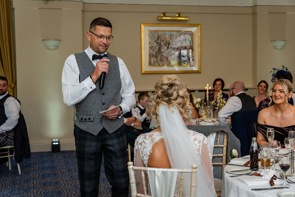 Groom delivering his wedding speech during the reception at Balbirnie House, surrounded by family and friends.