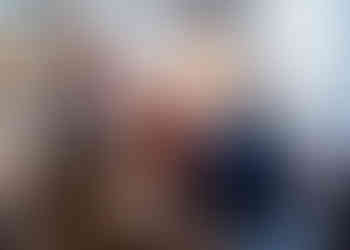 Guests laughing and enjoying the humorous speeches at the wedding reception.