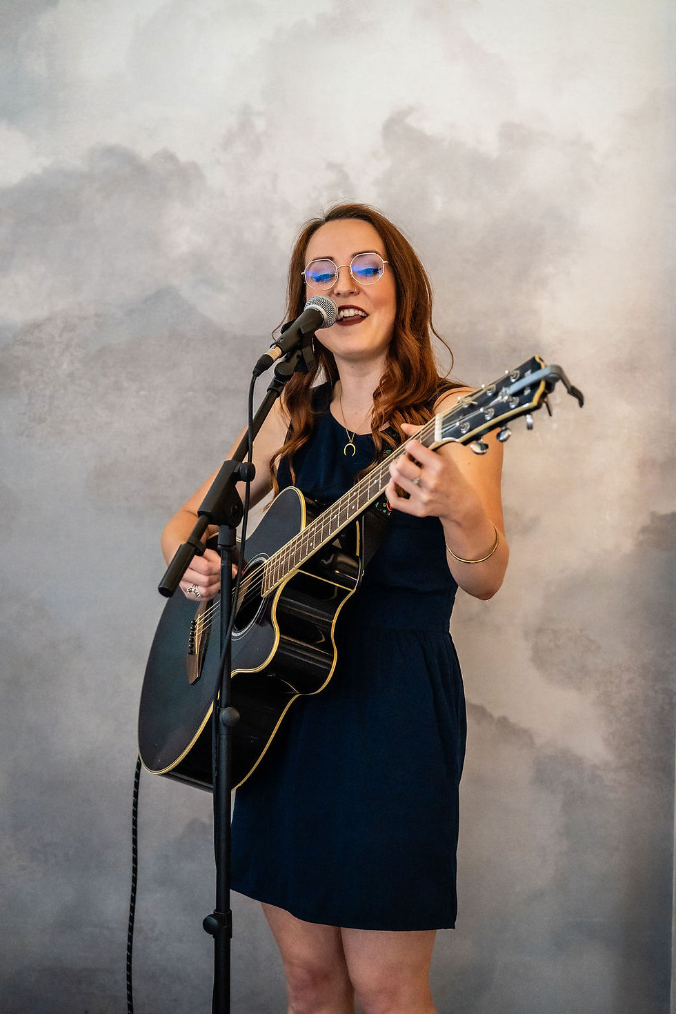 Live singer performing during the wedding ceremony at Balbirnie House, creating a personal atmosphere.