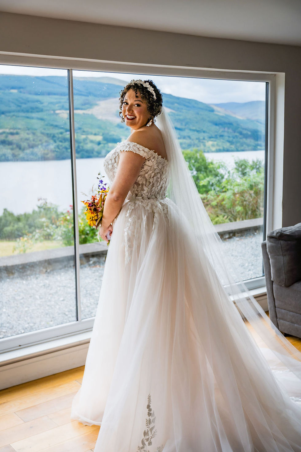 Bride standing in her wedding dress, ready for the ceremony at Boreland Loch Tay in the Scottish Highlands