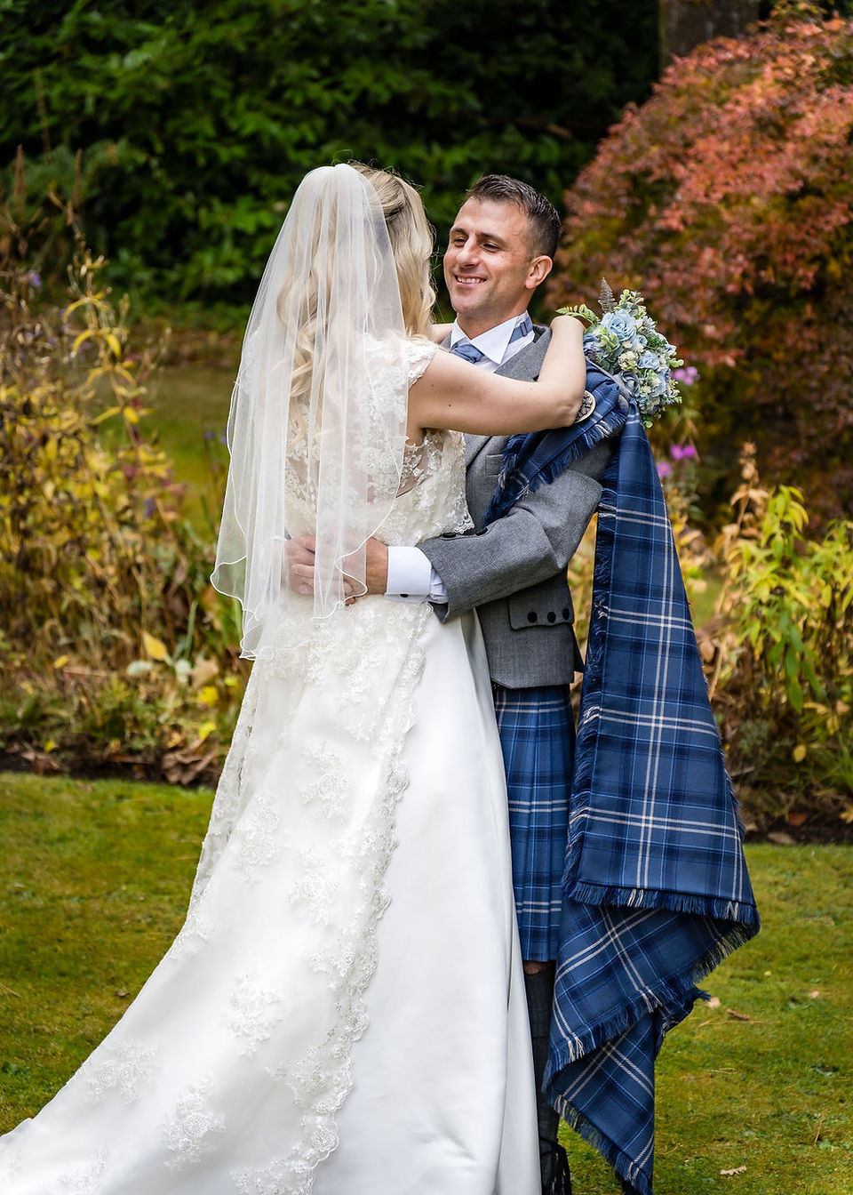  The couple sharing a tender gaze, surrounded by the beauty of Taypark House's gardens.