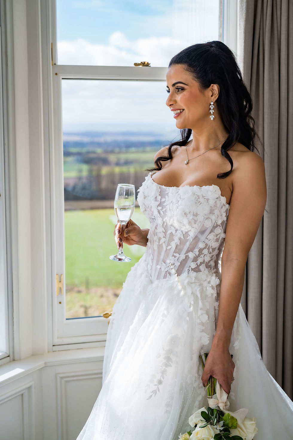 Bride in her wedding dress inside the bridal suite at Kinclune House, elegant Angus wedding venue.