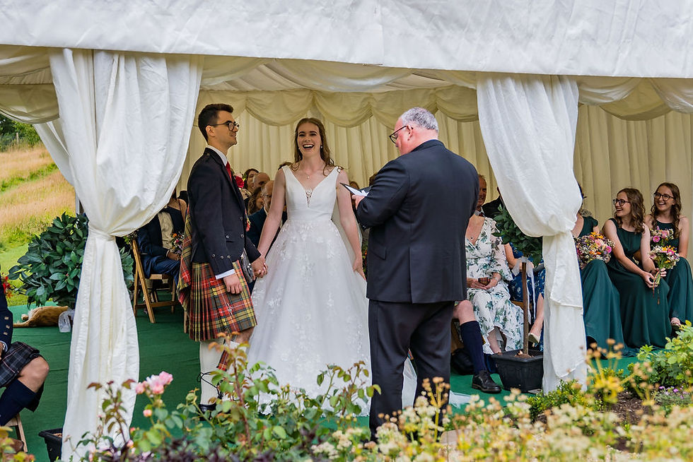A candid moment between the bride and groom during their wedding vows in Perthshire.