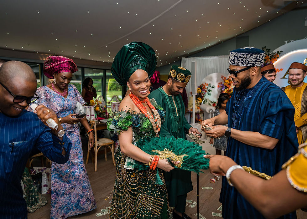 Nigerian Igbo couple dancing while money is sprayed over them during their Kinmount House wedding in Scotland, captured in a candid and joyful documentary style.