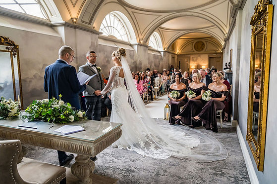 Wide view of bride and groom during ceremony at Balbirnie House surrounded by family and guests in Scotland