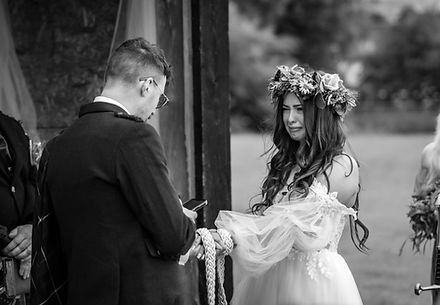Bride and groom exchanging vows in a romantic outdoor ceremony in the Scottish Highlands.