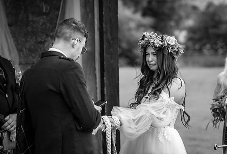 Bride and groom exchanging vows in a romantic outdoor ceremony in the Scottish Highlands.