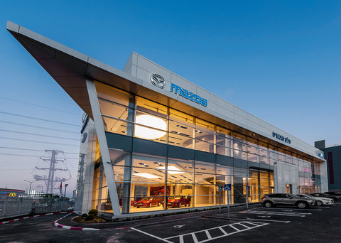 Facade with aluminium cladded overhand diagonal column and glass curtain wall