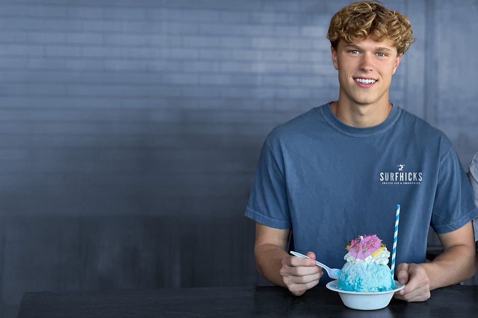 Surfer eating shaved ice smiling