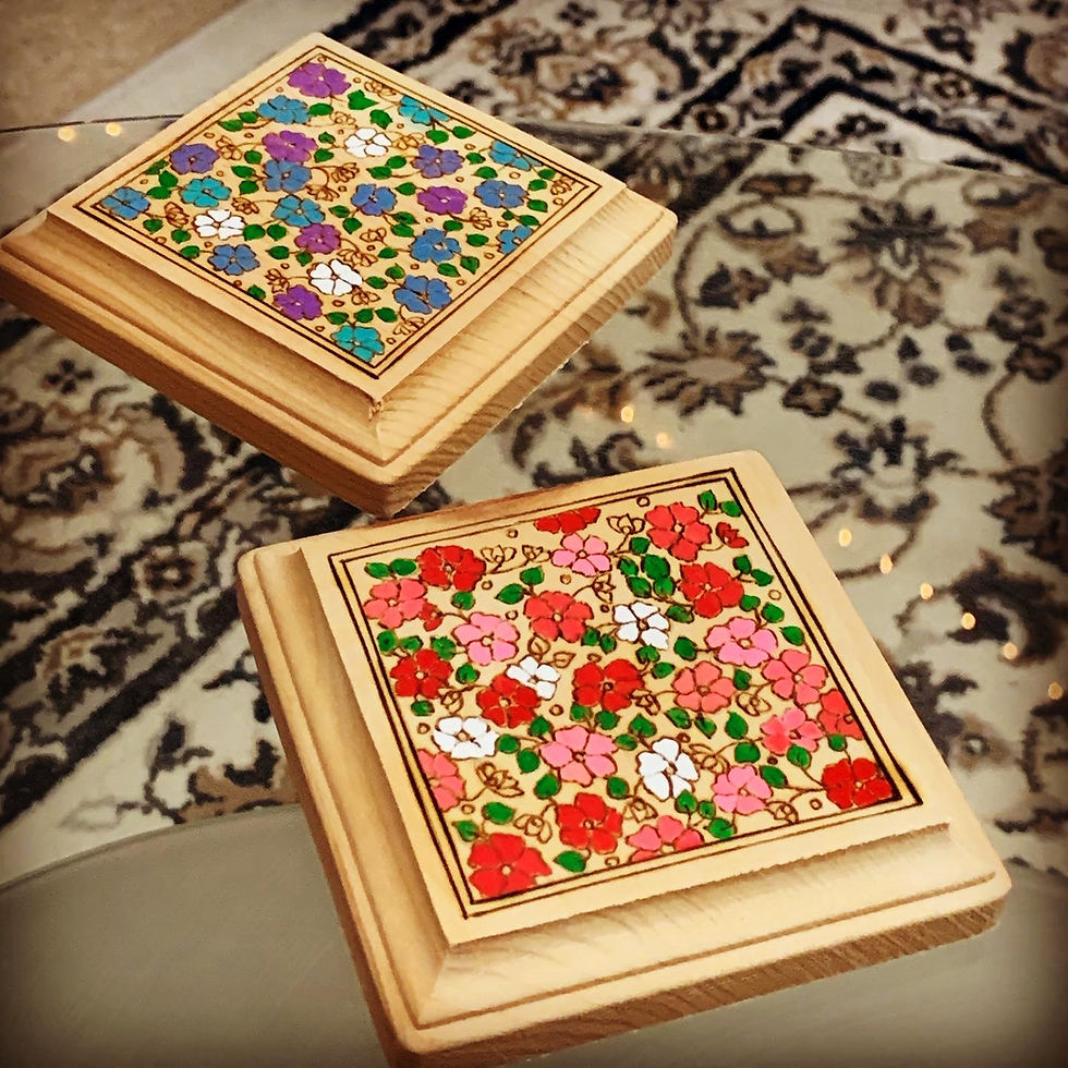 Two floral coasters on a patterned rug, floral carpet coasters, Gulmohar Wood Art.