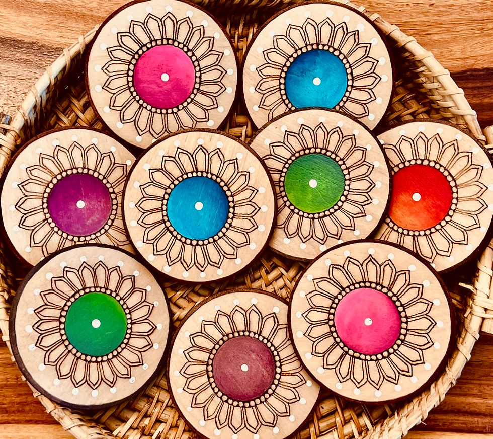 Wooden coasters with detailed patterns, colorful centers, and woven basket background.