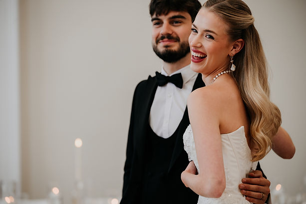 Couple laughing after getting married in Glossop