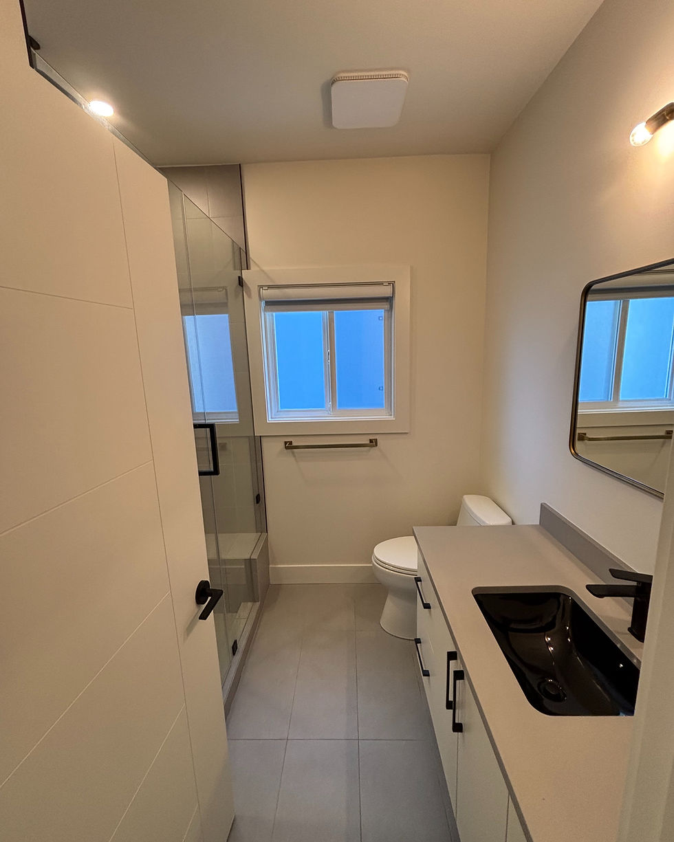 Bathroom renovation with custom shower, vanity, and tiled walls