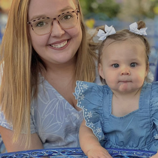 A mother and daughter smile for a picutre. 
