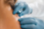 Physician with gloves examining a mole on someone