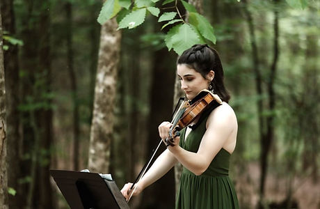 violinist playing in forest