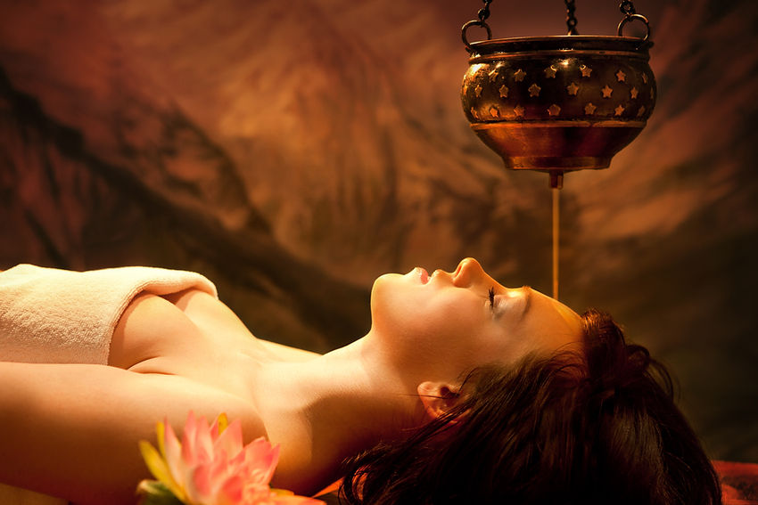 Spa salon_ Beautiful Young Woman having Shirodhara - Ayurveda Oil Massage in India Spa Sal