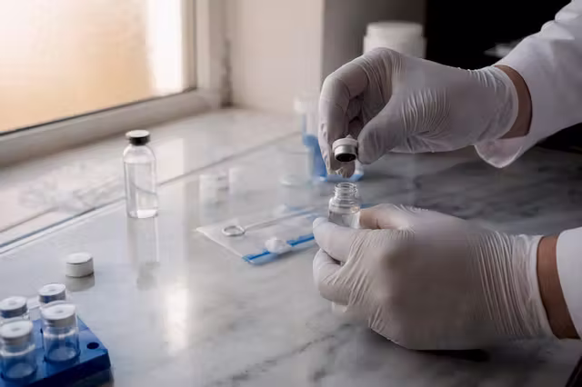 Hands weighing lyophilized peptide powder