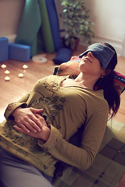 Attractive mixed race woman doing restorative yoga.jpg
