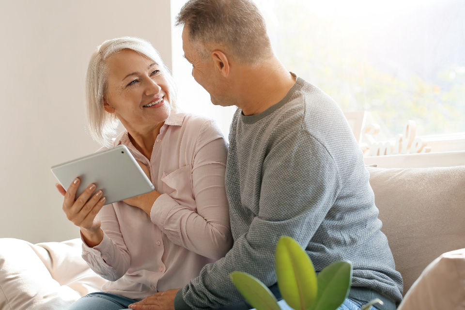 Retired couple reviewing Medicare plan options on a tablet at home