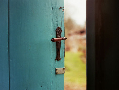 Rustic teal door opening to outside