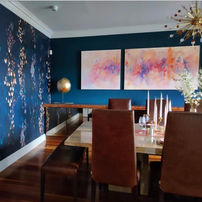 Dining room with copper accents and original artwork