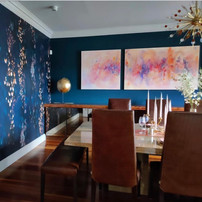 Dining room with copper accents and original artwork