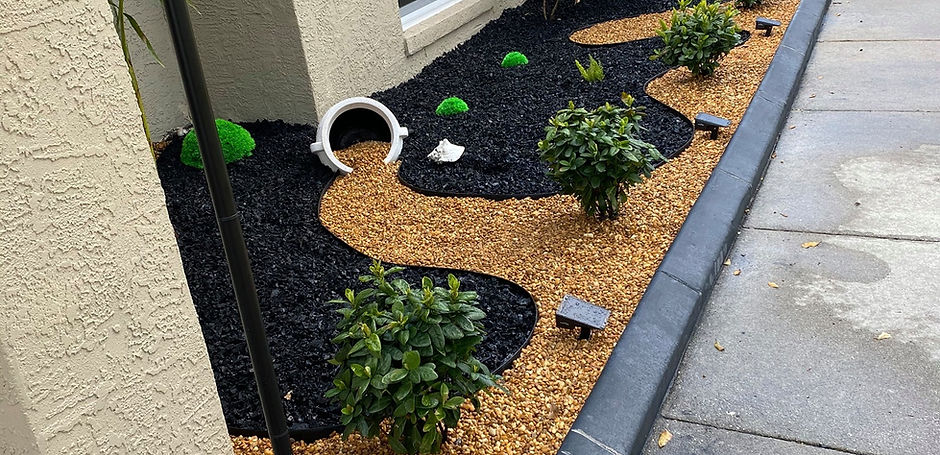 River rock, rubber mulch, plants, garden bed design