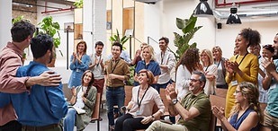 employees coming together and congratulating others at a meething