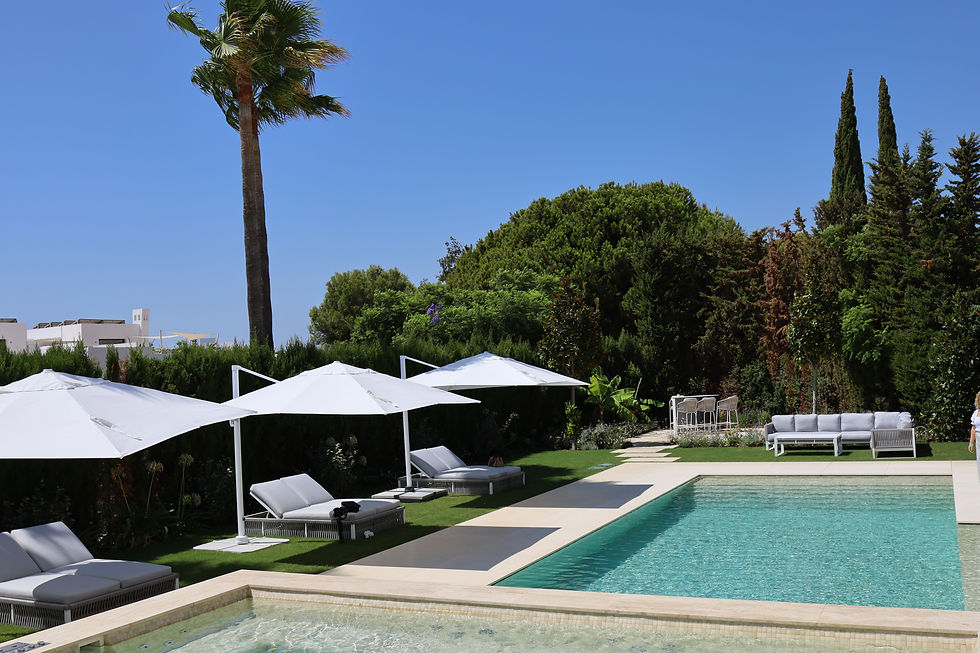 Poolside in Marbella with trees and blu sky
