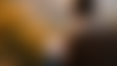 Person journaling outdoors overlooking mountains, representing reflection, faith, and inner transformation.