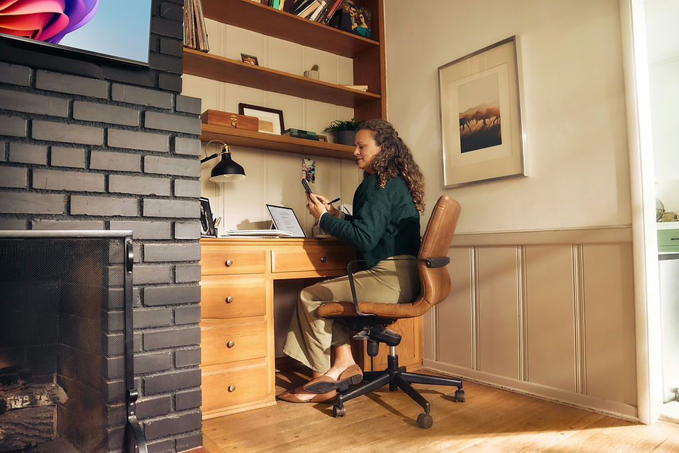 Woman sitting at a desk looking at her phone