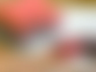 Stack of colorful fat quarters and a rotary cutter on a gridded cutting mat, perfect for beginner quilting.