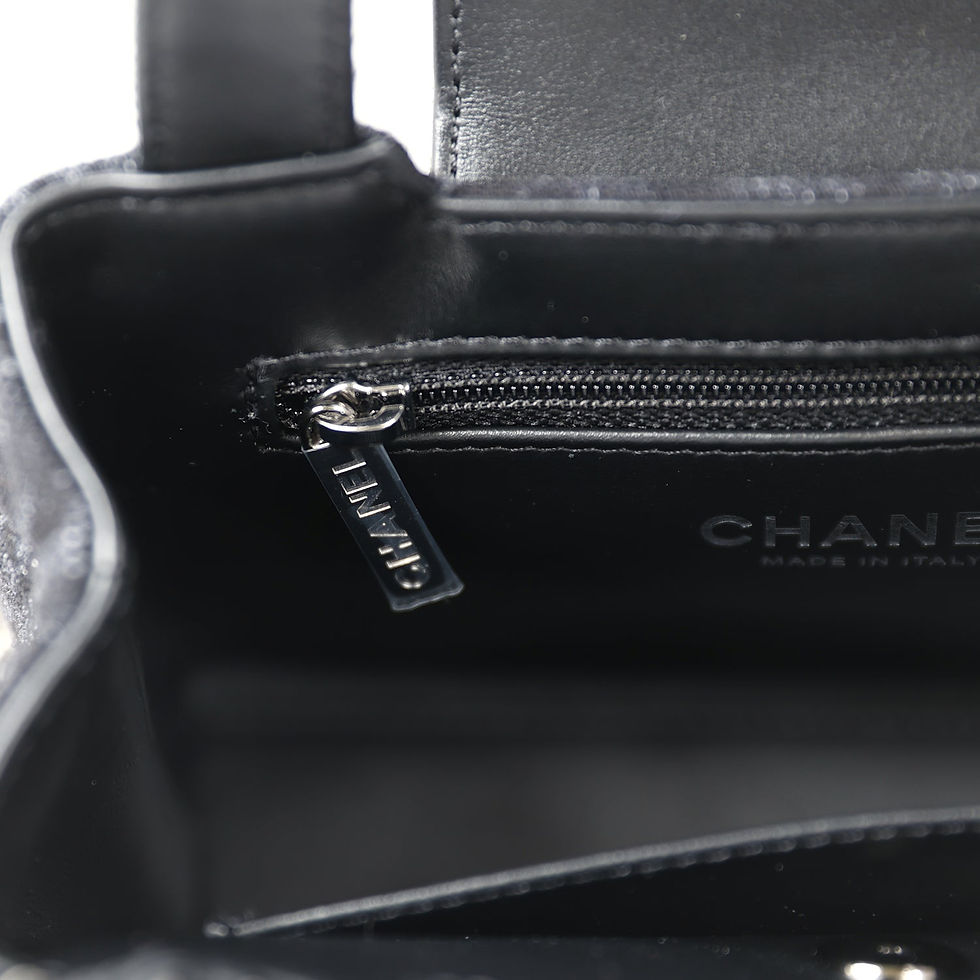 Thumbnail: Close-up of the zip pull and handle attachment with the Chanel-branded tag visible