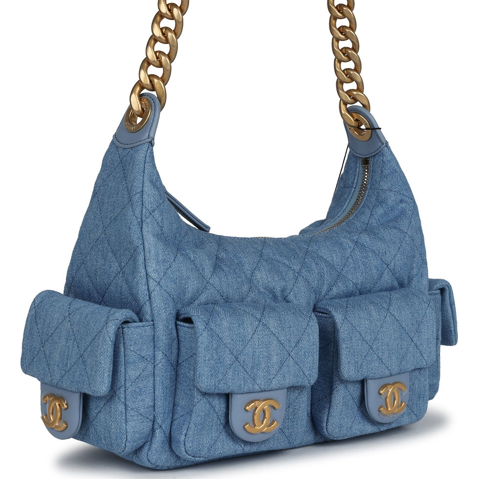 Side-angle view showing the bag's chain-link strap and quilted denim pockets