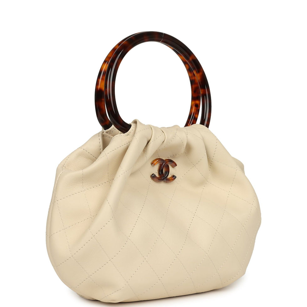 Three-quarter angled view of the light beige calfskin pouch showing its gathered opening