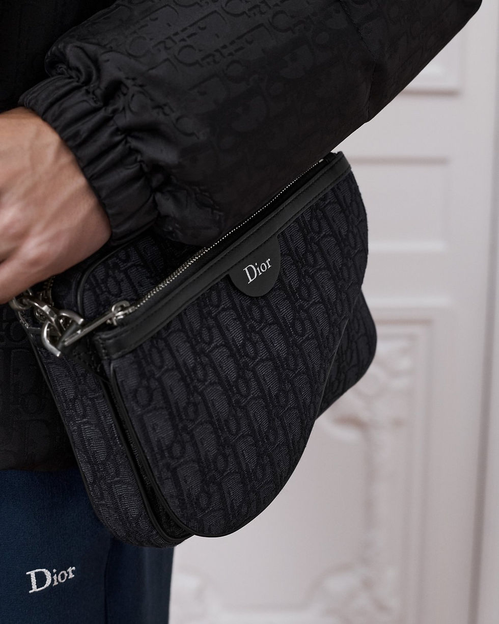 Dior Saddle Triple Pouch in black cotton and calfskin – worn on model, close-up