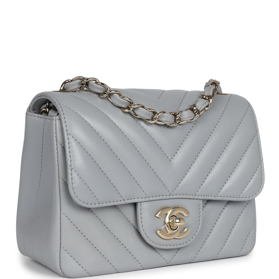 Three-quarter view of the light grey chevron flap bag showing the CC turnlock