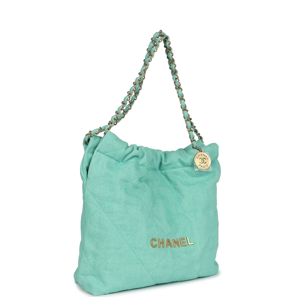 Angled front view of the mint-green denim bag showing the CHANEL wordmark