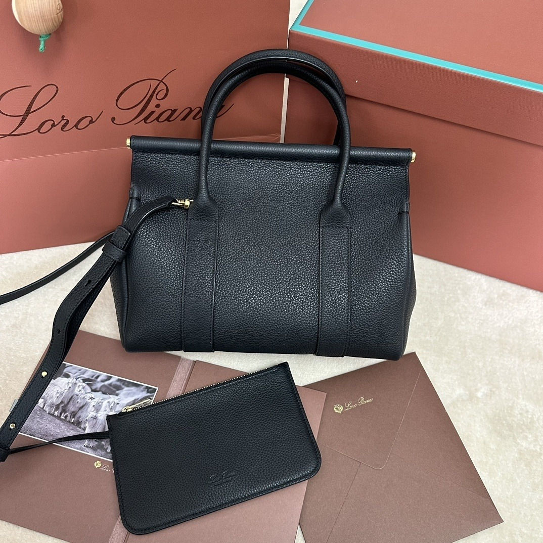 Front view of the Loro Piana Loom Bag L32 in black grained calfskin with its matching pouch