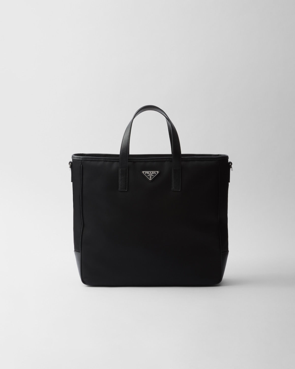 Prada compact tote bag in black Re-Nylon and Saffiano leather – front view