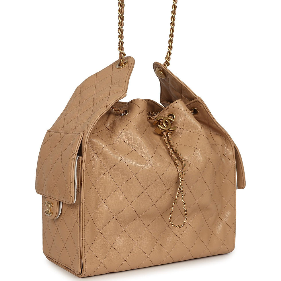 Angled front view showing the beige quilted body, chain drawstring and side pocket