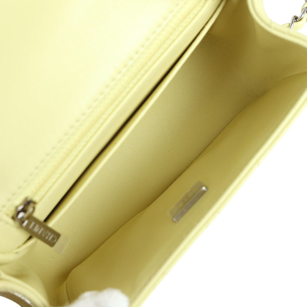 Thumbnail: Partial interior view of the bag showing the zip pocket and silver-toned Chanel tag