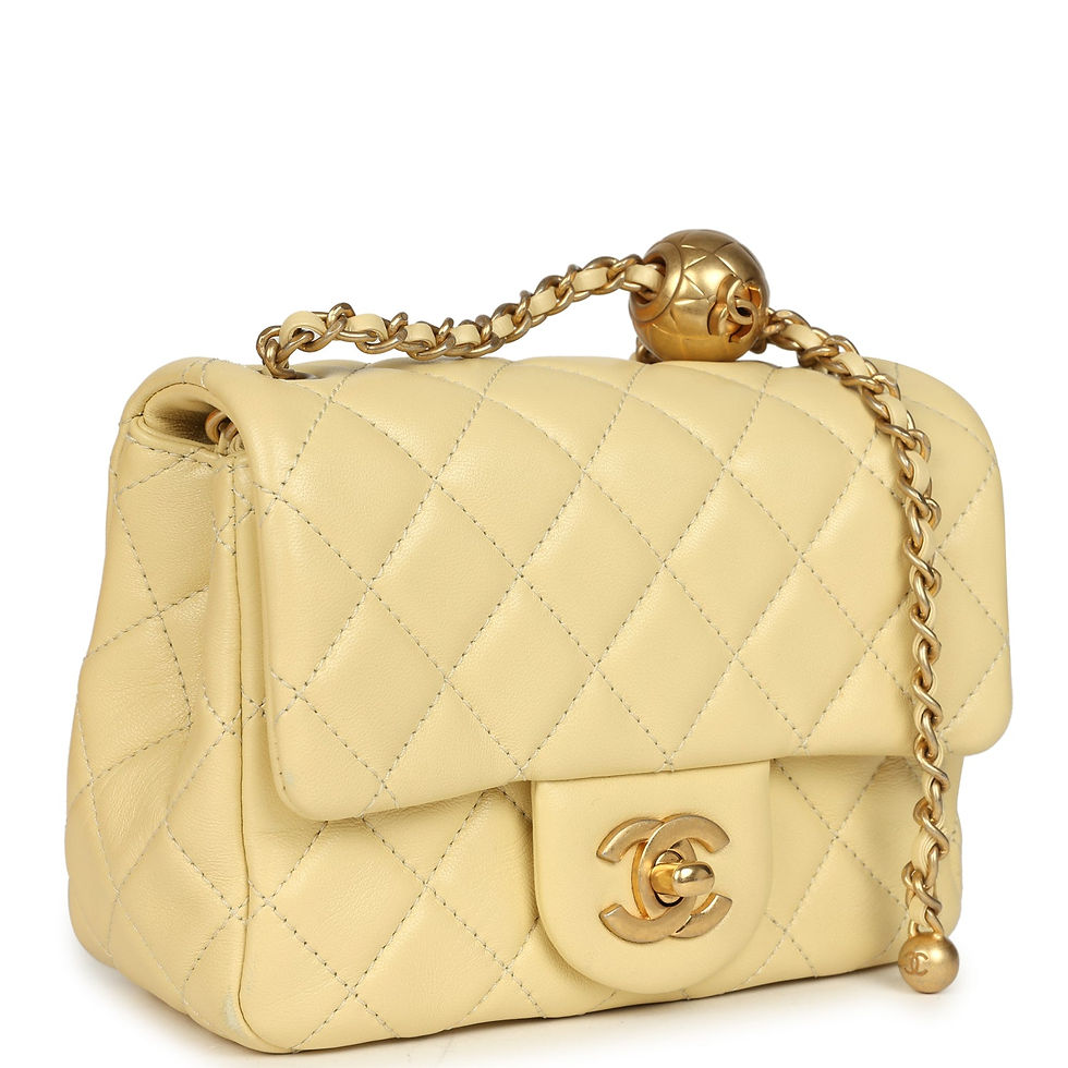Three-quarter angled view showing the diamond-quilted yellow lambskin and gold chain strap