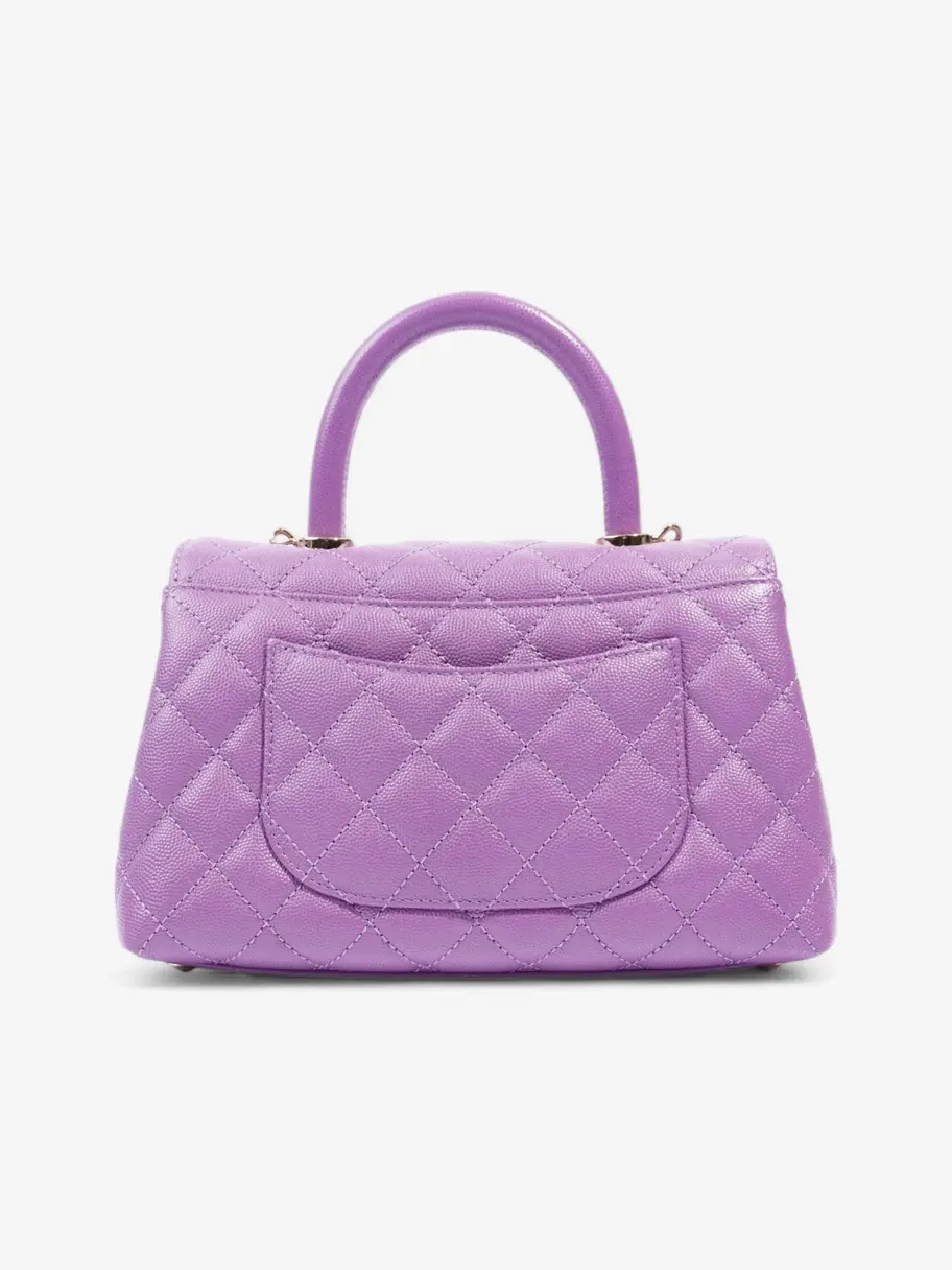 Thumbnail: The purple Coco Handle bag held by its rolled leather top handle