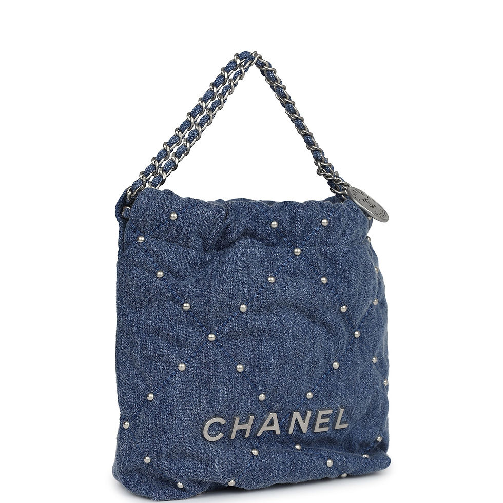 Angled front view of the blue studded denim bag showing the rubberised CHANEL wordmark