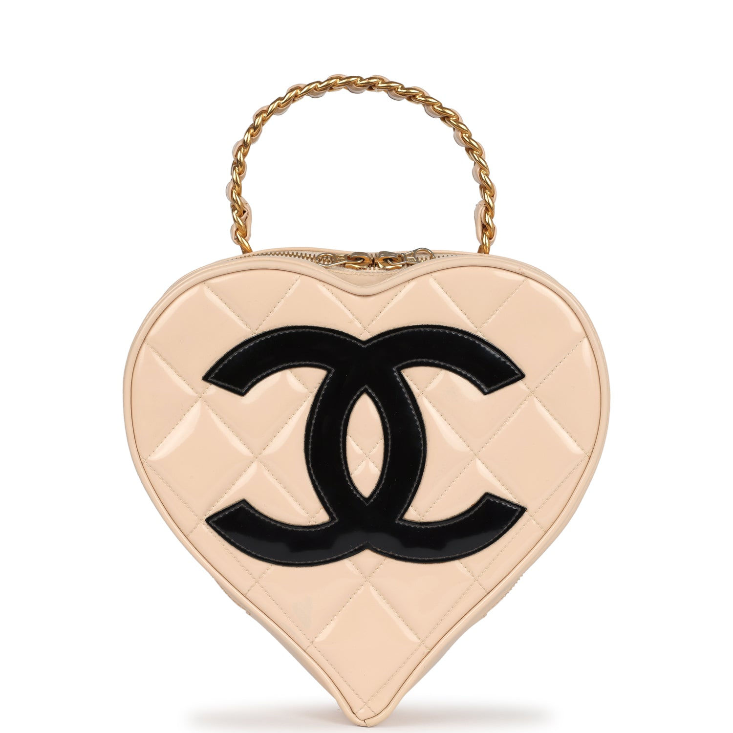 Front view of the heart-shaped vanity bag with black CC logo on beige patent leather