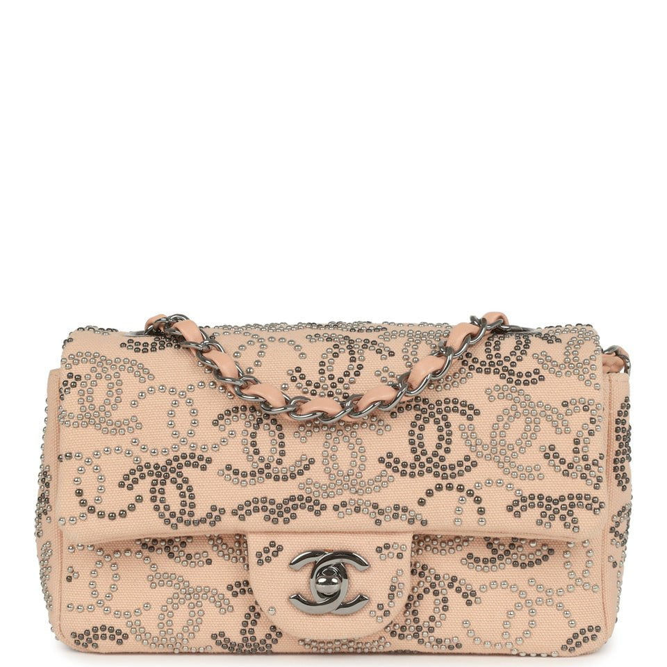 Front view of the Chanel CC Studded Rectangular Flap Bag in light pink canvas with a ruthenium turn-lock